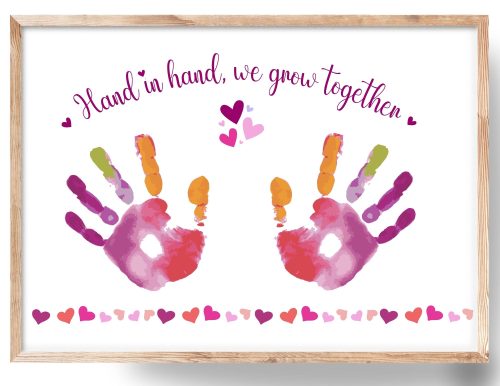 a framed handprint craft with text Hand in Hand, we grow together